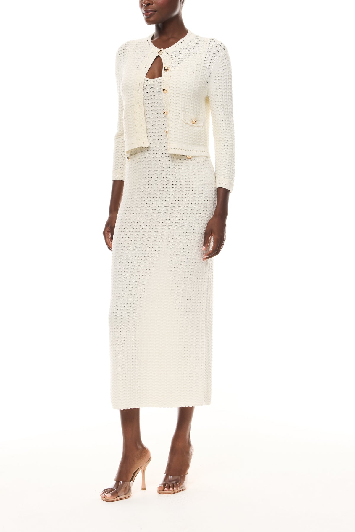 Monique Lhuillier Spring 2026 Ivory Cotton Viscose Knit Lace stitch cardigan with gold buttons with coordinating dress - side.