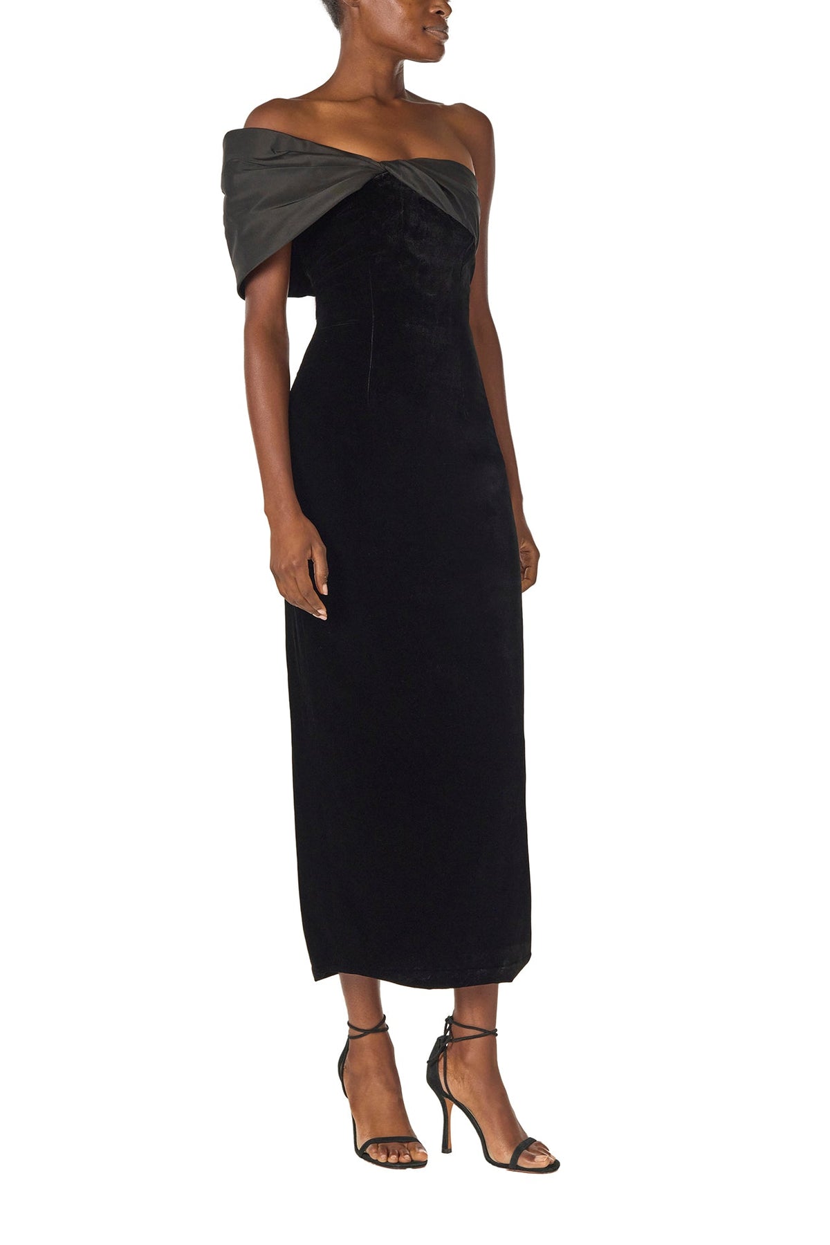 Monique Lhuillier Fall 2024 asymmetric, off the shoulder sheath dress in noir silk faille and velvet with draped twist detail at neckline - right side.